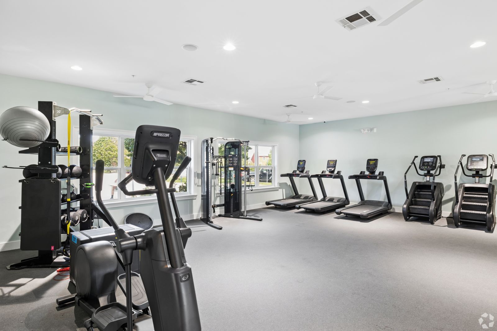 Fitness center with treadmills, ellipticals, weight machines, and other exercise equipment